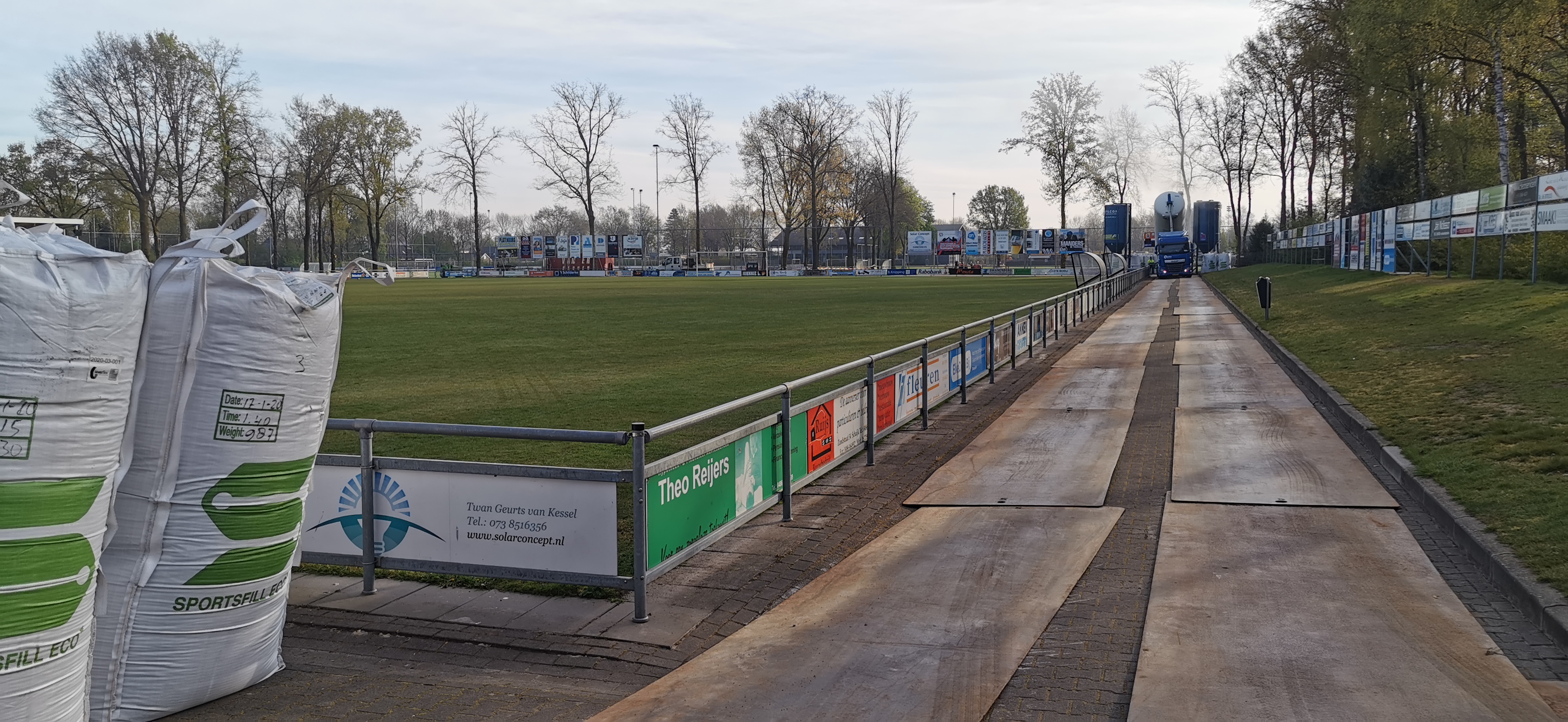 Vrachtwagen lost zand op platform van rijplaten